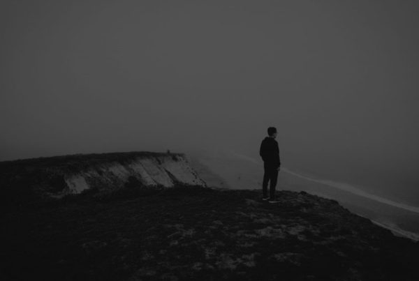 RFP response, man standing on cliff, waterfall