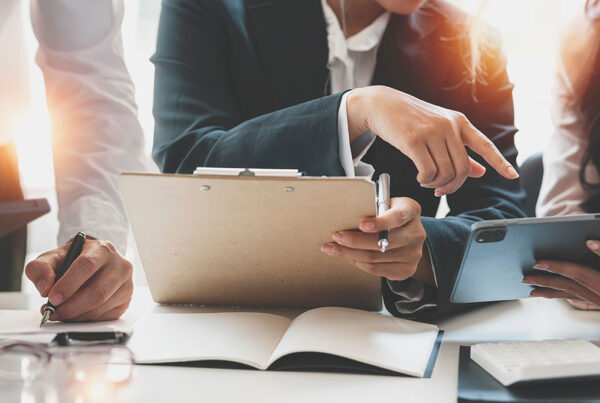 Cropped shot of diverse coworkers working together in boardroom,